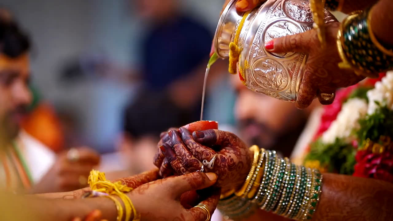 Water poured over the couple's joined hands