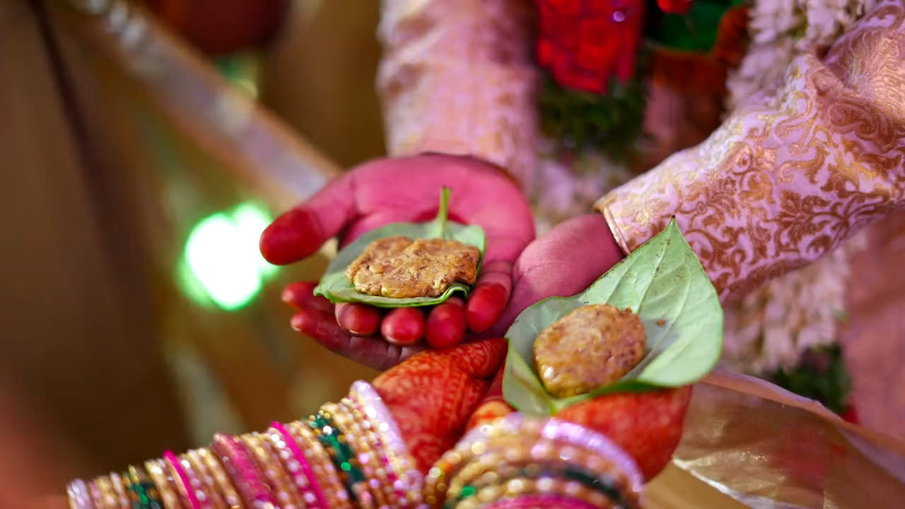 Jeelakarra-bellam on betel leaves, held in the hands of the bride and groom