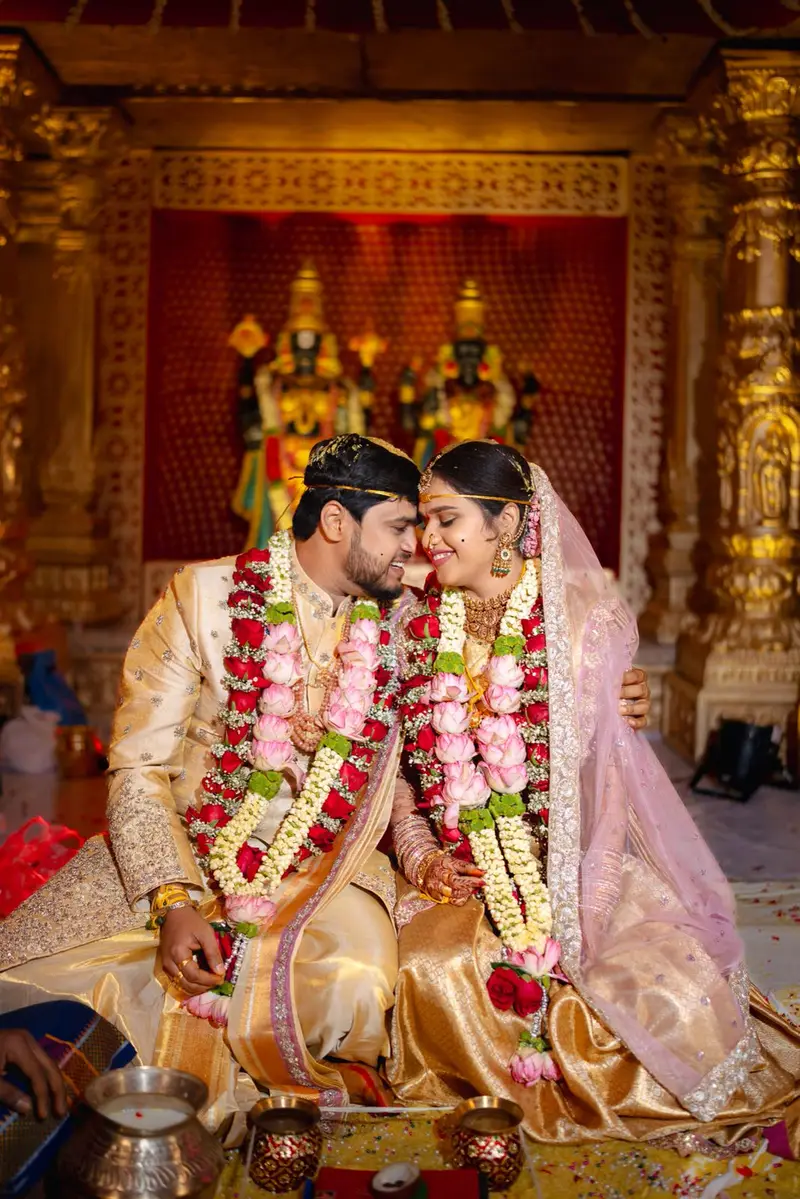 Album page: a couple in heavy garlands seated before a gilded shrine