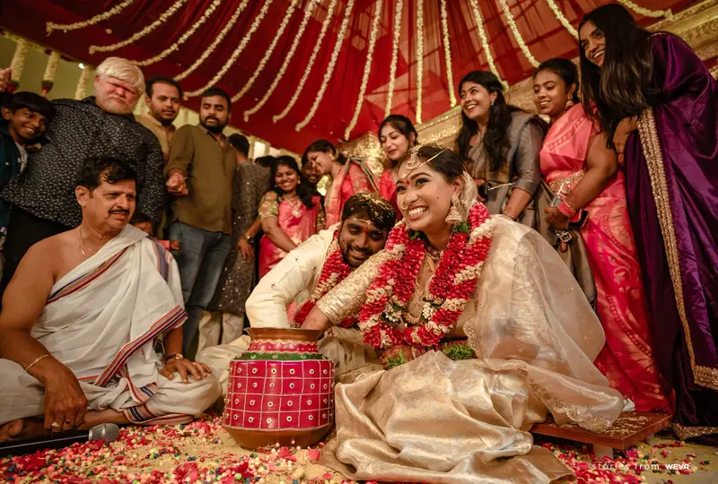 family gathered at the mandapam under a red canopy
