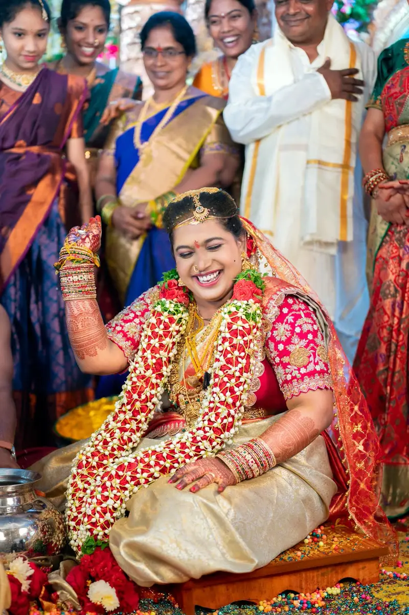 bride laughing among relatives during the ring game; colourful, joyous