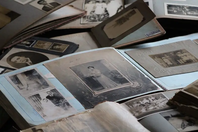 a pile of vintage photographs and old albums