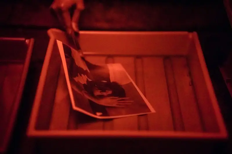 a print surfacing in a developer tray under red light