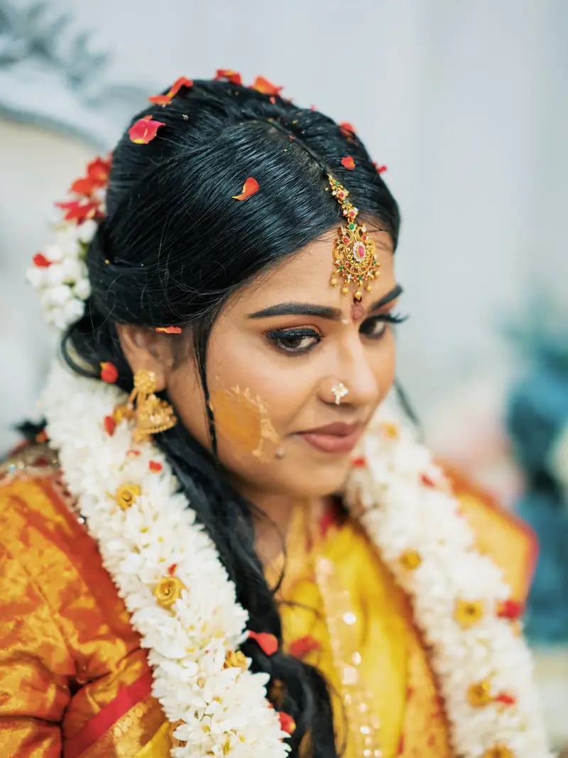 bride with turmeric and jasmine, a gentle smile, yellow silk